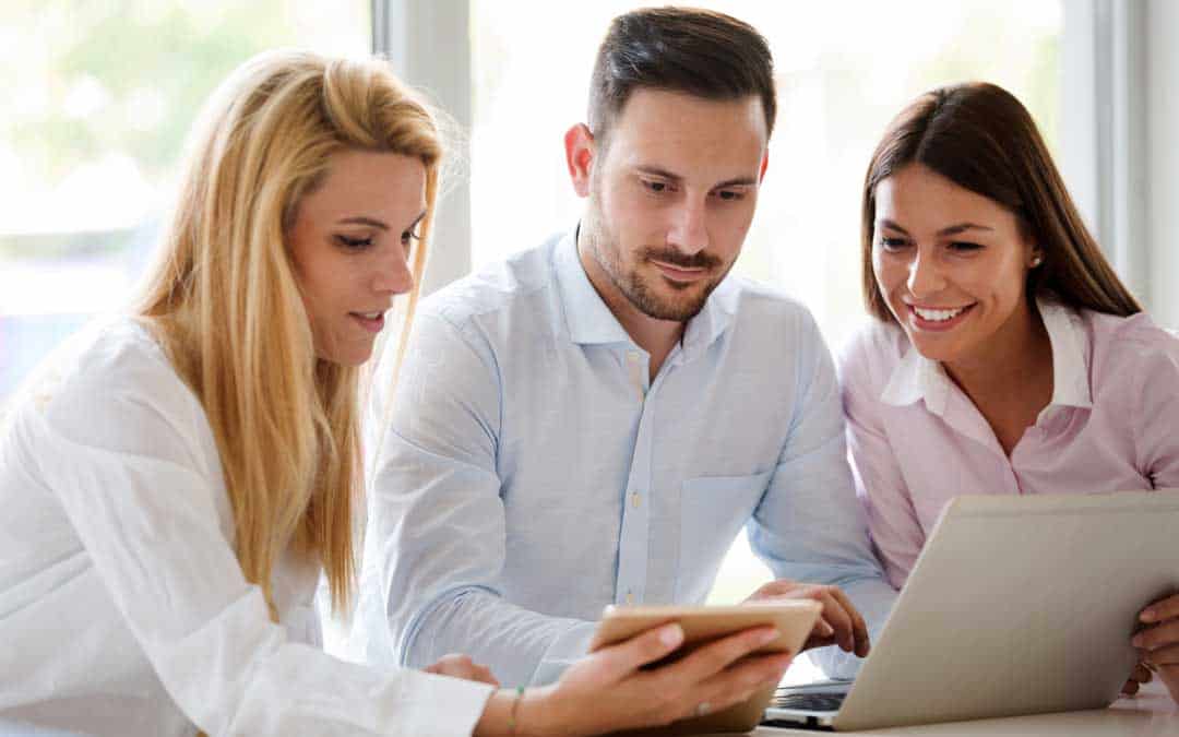 full-service-workteam-in-office-working-together-on-laptop workteam in office working together on laptop